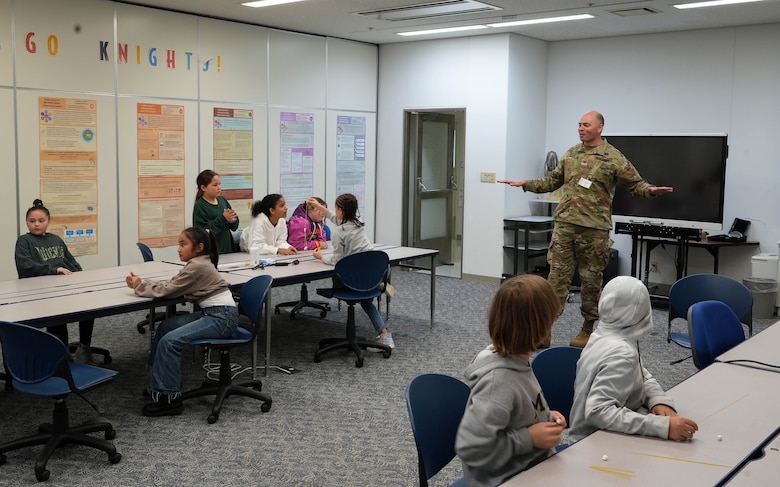 Col. Patrick Biggs, Commander of the U.S. Army Corps of Engineers – Japan District (USACE JED) explains the fundamentals of engineers to a group of John O. Arnn Elementary School students during their annual Science, Technology, Engineering, Art, and Mathematics (STEAM) Day event, April 23, 2025. As part of the Department of Defense Education Activity (DoDEA) curriculum, Arnn’s STEAM Day is a fast-paced event where students are introduced to the dynamic world of STEAM.