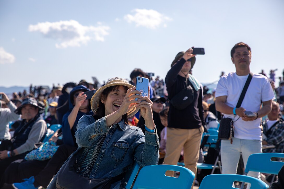 A guest observes a flight demonstration during the Japan Maritime Self-Defense Force-Marine Corps Air Station Iwakuni Friendship Day at MCAS Iwakuni, Japan, May 4, 2025. The JMSDF-MCAS Iwakuni Friendship Day is hosted annually to strengthen relationships with the host community and offer a cultural exchange that highlights the mutual support between the U.S. and Japan. (U.S. Marine Corps photo by Cpl. Colin Thibault)