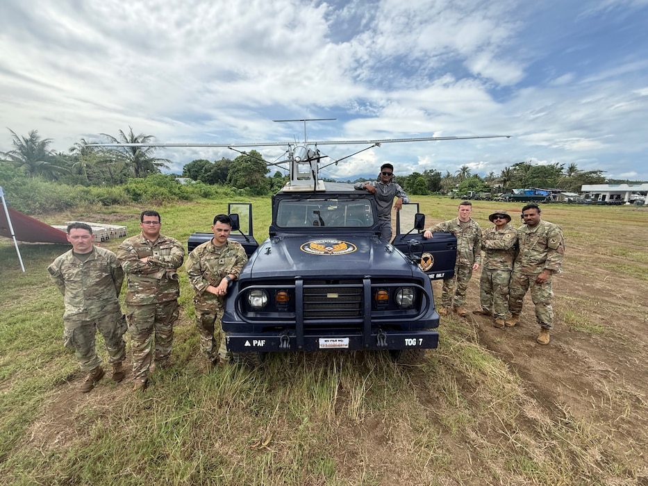 U.S. Army soldiers with 1st Multi-Effects Battalion, 1st Multi-Domain Task Force and a service member from the Philippine Air Force pose for a group photo after mounting an Unmanned Aerial System to the roof of a Philippine Air Force vehicle in preparation to use as a launch vehicle for future flights during Exercise Balikatan 25 in Palawan, Philippines, May 1, 2025.