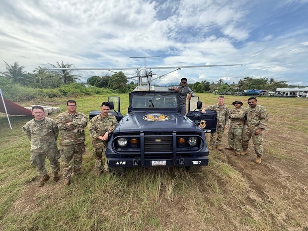U.S. Army soldiers with 1st Multi-Effects Battalion, 1st Multi-Domain Task Force and a service member from the Philippine Air Force pose for a group photo after mounting an Unmanned Aerial System to the roof of a Philippine Air Force vehicle in preparation to use as a launch vehicle for future flights during Exercise Balikatan 25 in Palawan, Philippines, May 1, 2025.