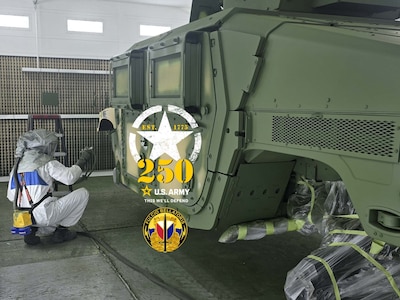 Fabian Vanhaecht sprays a Humvee with olive drab green paint at the Logistics Readiness Center Benelux paint booth. Since August, Vanhaecht has worked there as an autobody technician. “When I applied for this job last year, I didn’t know the Army would be celebrating its 250th birthday in 2025. Now that I know this, I’m happy to be a part of the team on this special year. Happy 250th birthday, U.S. Army!” he said. (Photo by Giancarlo Giardina)
