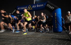 Participants sprint from the starting line during the Royal Air Force Falcons Launch 5K Run within the U.S. Central Command area of responsibility, May 1, 2025. The event gave coalition forces an opportunity to engage in camaraderie and friendly competition.(U.S. Air Force photo by Senior Airman Dieondiere Jefferies)