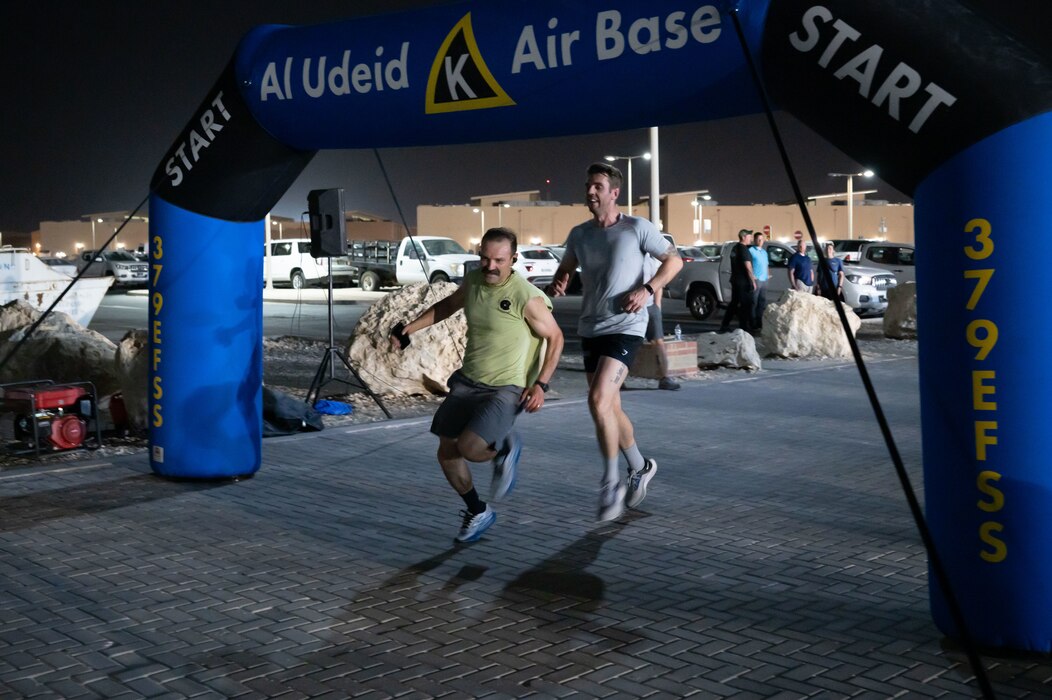Royal Air Force Falcons Launch 5K Run participants compete through the finish line within the U.S. Central Command area of responsibility, May 1, 2025. Based at RAF Brize Norton in Oxfordshire, the Falcons are the United Kingdom’s leading military parachute display team, performing at events across Europe throughout the year. (U.S. Air Force photo by Senior Airman Dieondiere Jefferies)