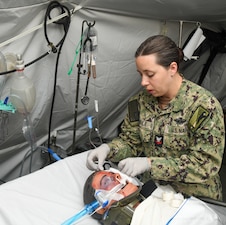 ospital Corpsman Second Class Korina Mabile cleans the wound of a simulated casualty during the Expeditionary Medical Facility Kilo (EMF-Kilo) Operational Readiness Exercise (ORE) on Fort McCoy, Wisconsin, April 30, 2025. EMF-Kilo is the readiness platform attached to Navy Medicine Readiness and Training Command Camp Lejeune and is comprised of approximately 400 personnel ready to deploy field hospital capabilities during humanitarian or combat mission.