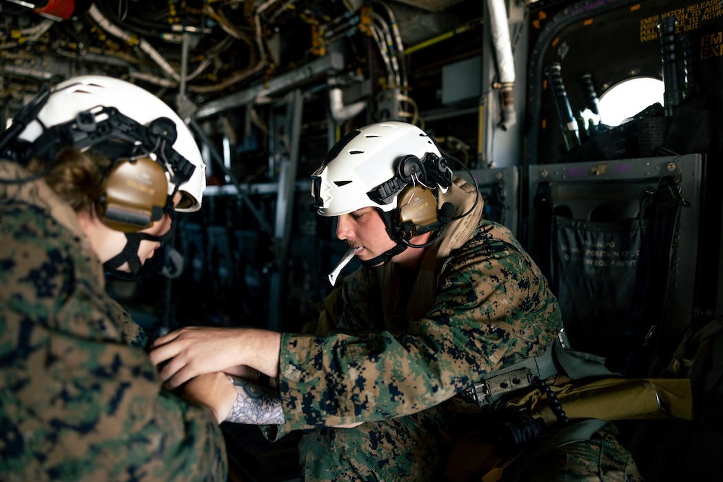 250428-M-FG738-1131 U.S. Navy Petty Officer 3rd Class Michael Boyd, right, a hospital corpsman with Marine Medium Tiltrotor Squadron (VMM) 364, Marine Air Group 39, 3rd Marine Aircraft Wing, treats Petty Officer 1st Class Lacie Huckabie, right, a hospital corpsman with VMM-364,  MAG 39, during a simulated tactical recovery of aircraft and personnel exercise as part of Exercise Balikatan 25 over the South China Sea on April 28, 2025. Balikatan is a longstanding annual exercise between the Armed Forces of the Philippines and U.S. military designed to strengthen our ironclad alliance, improve our capable combined force, and demonstrate our commitment to regional security and stability. (U.S. Marine Corps Photo by Cpl. Brian Knowles)