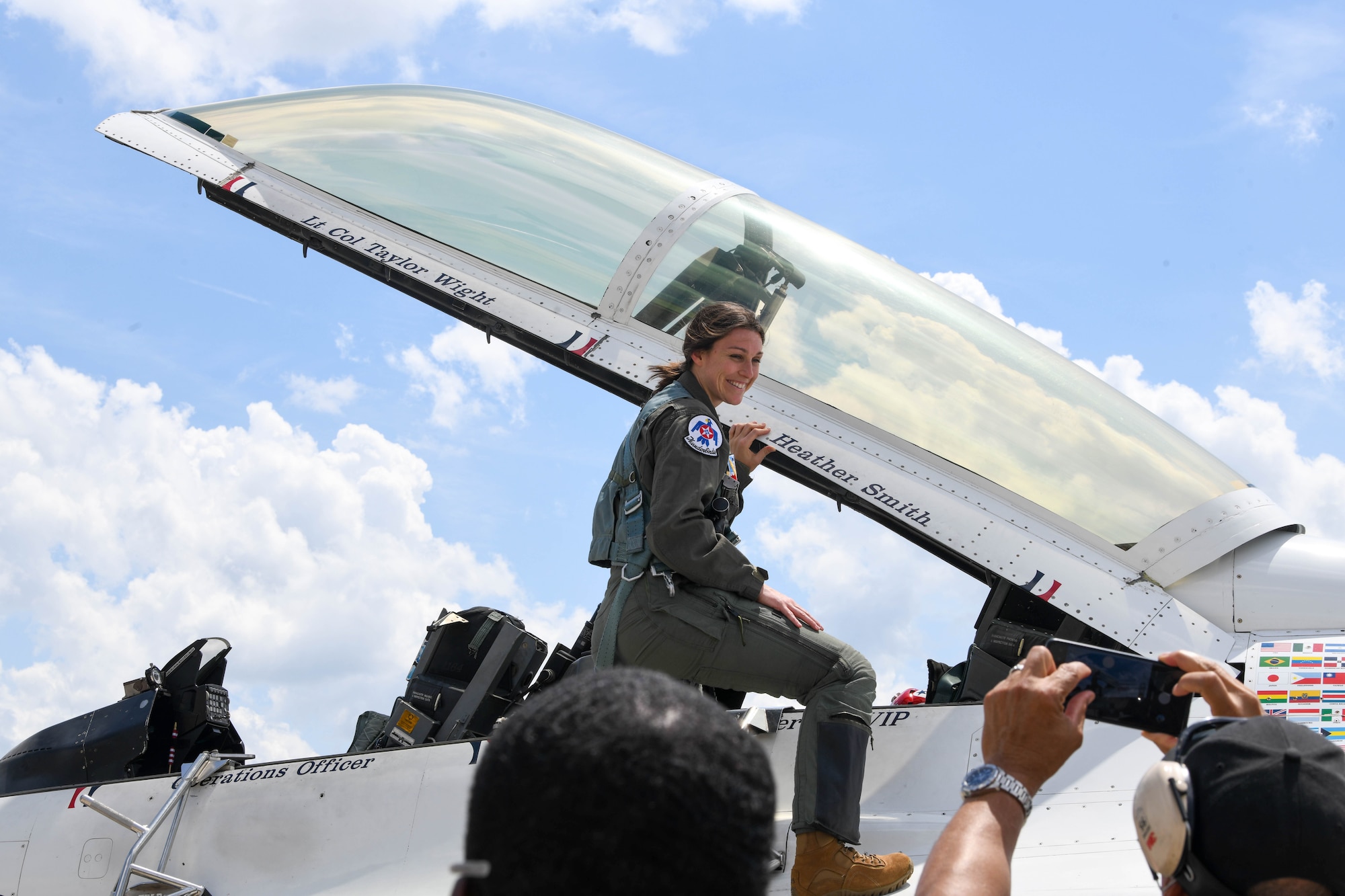 Heather Smith, hometown Hero participant, poses for a picture on an F-16 Fighting Falcon, assigned to the U.S. Air Force Demonstration Squadron "Thunderbirds", before an incentive flight at Seymour Johnson Air Force Base, North Carolina, May 2, 2025. Despite her demanding career and volunteer commitments, Smith is a devoted wife and mother, demonstrating that dedication to service can coexist with a fulfilling family life. (U.S. Air Force photo By Senior Airman Taylor Hunter)