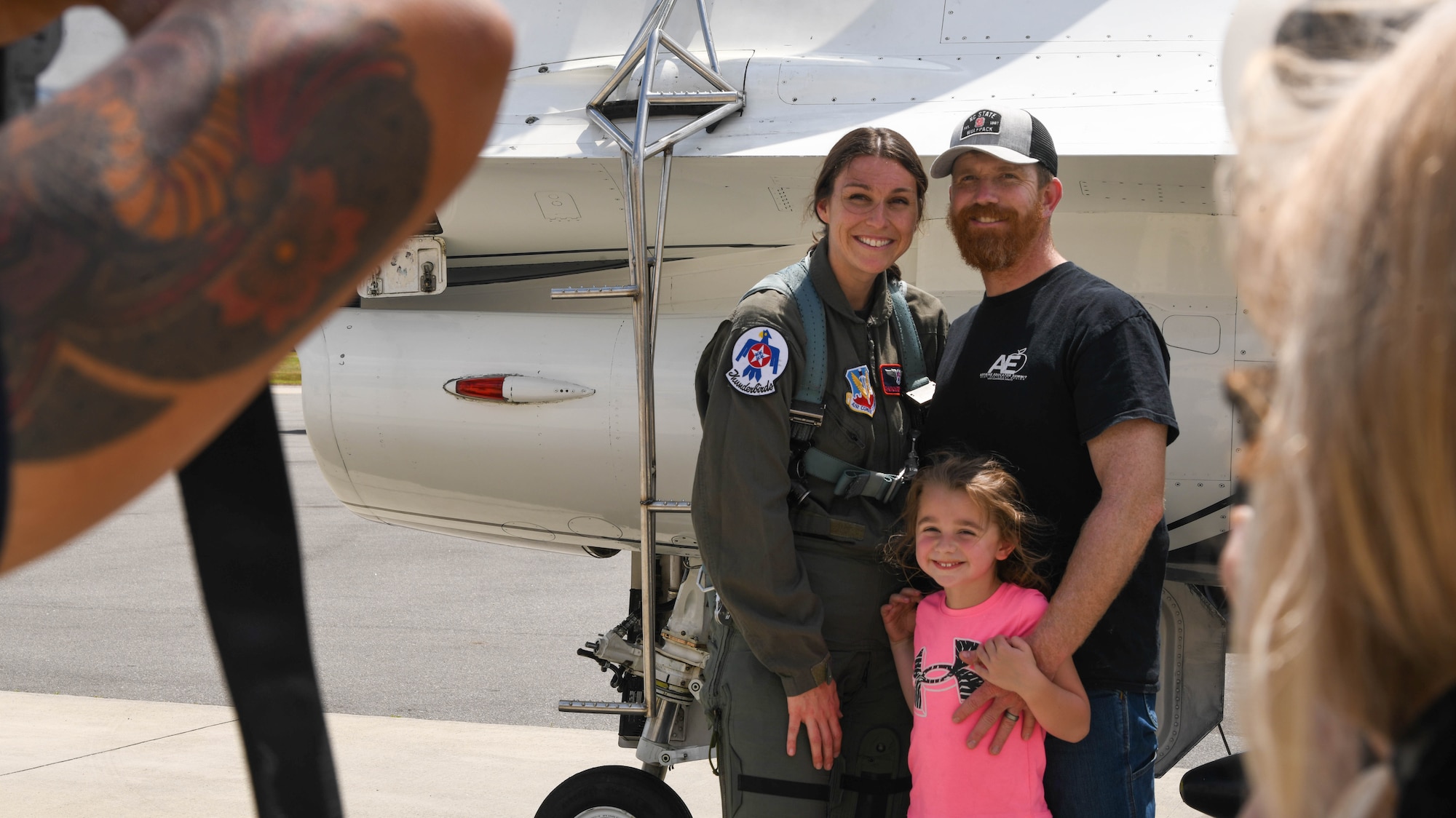 Heather Smith, hometown Hero participant, poses for a picture with her family in front of a F-16 Fighting Falcon, assigned to the U.S. Air Force Air Demonstration Squadron "Thunderbirds", before an incentive flight at Seymour Johnson Air Force Base, North Carolina, May 2, 2025. Despite her demanding career and volunteer commitments, Smith is a devoted wife and mother, demonstrating that dedication to service can coexist with a fulfilling family life. (U.S. Air Force photo By Senior Airman Taylor Hunter)