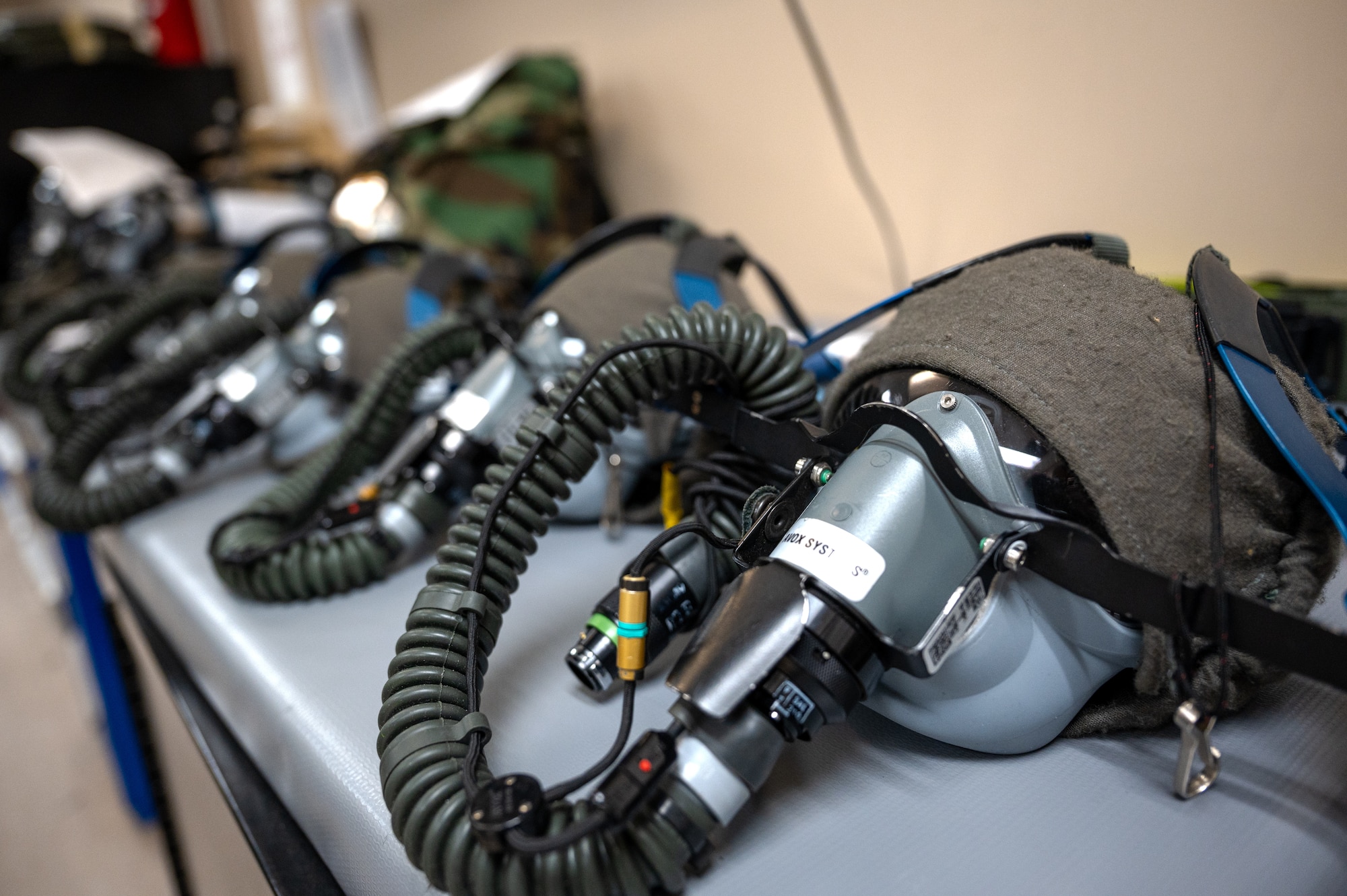 Staged oxygen masks on a table that are lined up and ready for inspection at Hurlburt Field.