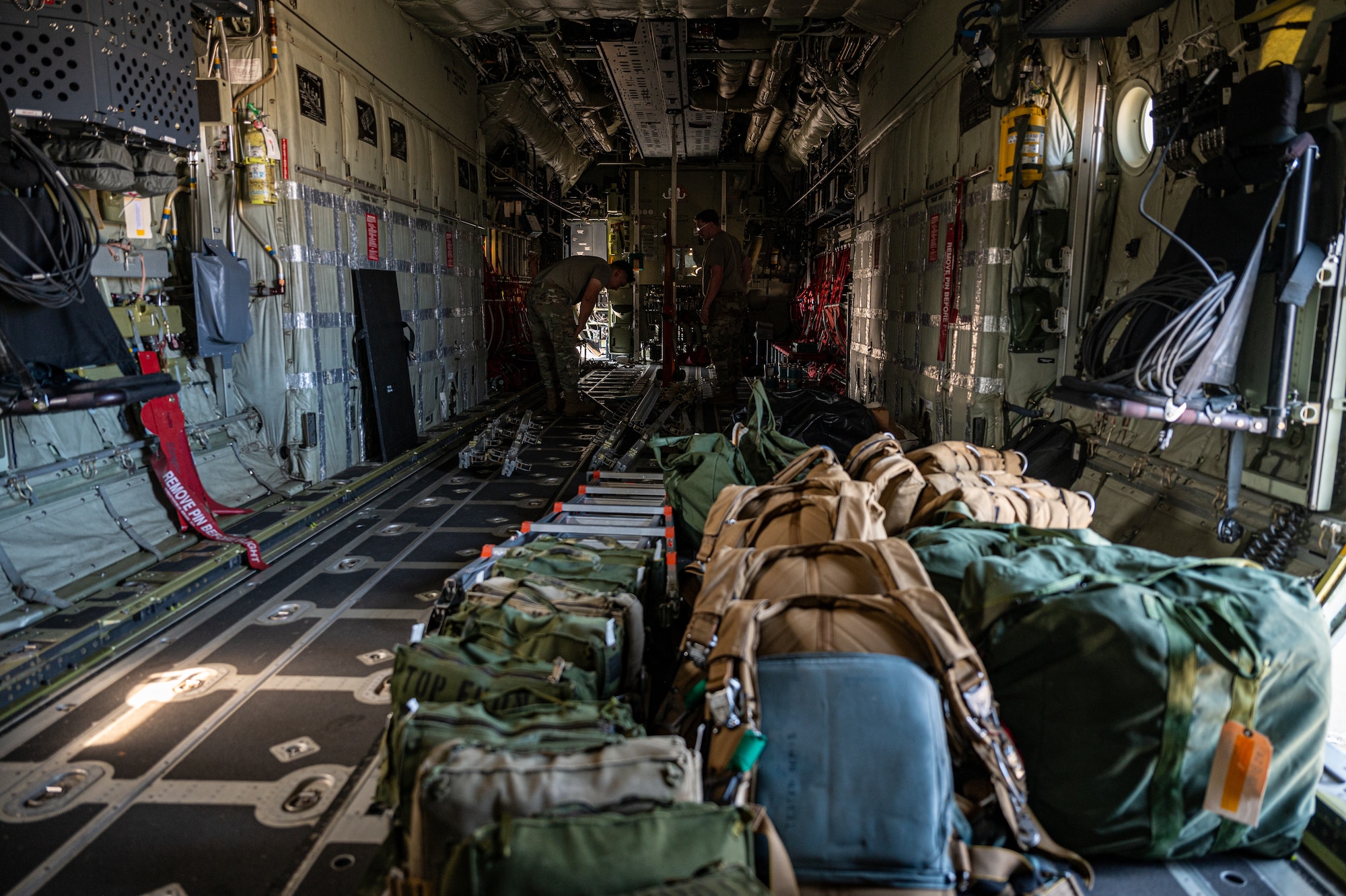 Aircrew Flight Equipment technicians offload survival gear inside an aircraft following a completed flight at Hurlburt Field.