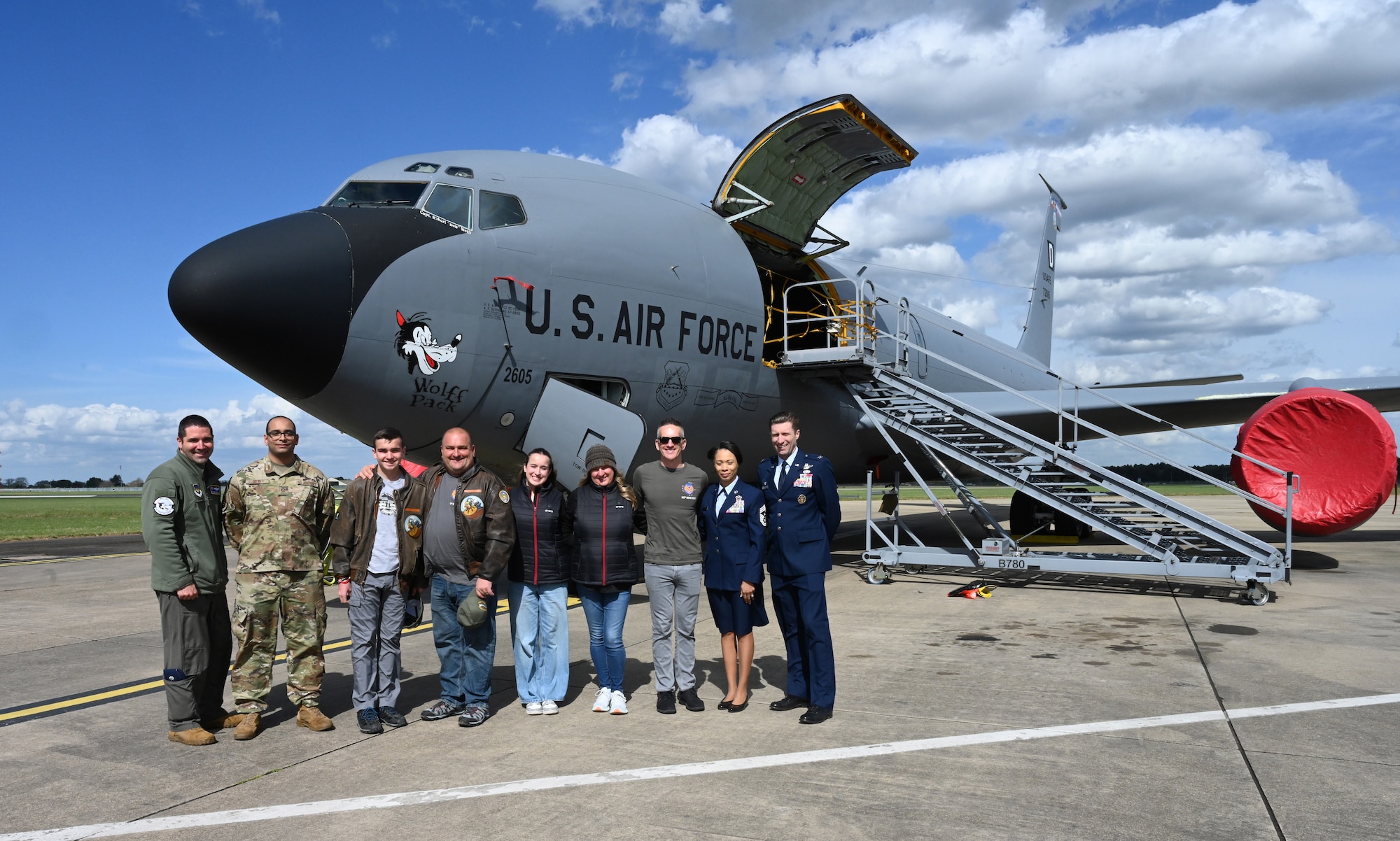 U.S. Air Force leadership and Airmen from the 100th Air Refueling Wing show a KC-135 Stratotanker bearing the “Wolff Pack” nose art to family members of U.S. Army Air Corps Capt. Robert “Bob” Wolff, World War II and 100th Bomb Group veteran, at RAF Mildenhall, England, April 16, 2025. Wolff was a B-17 Flying Fortress pilot. He and his crew were nicknamed the “Wolff Pack,” as was their aircraft they flew several missions in. (U.S. Air Force photo by Karen Abeyasekere)