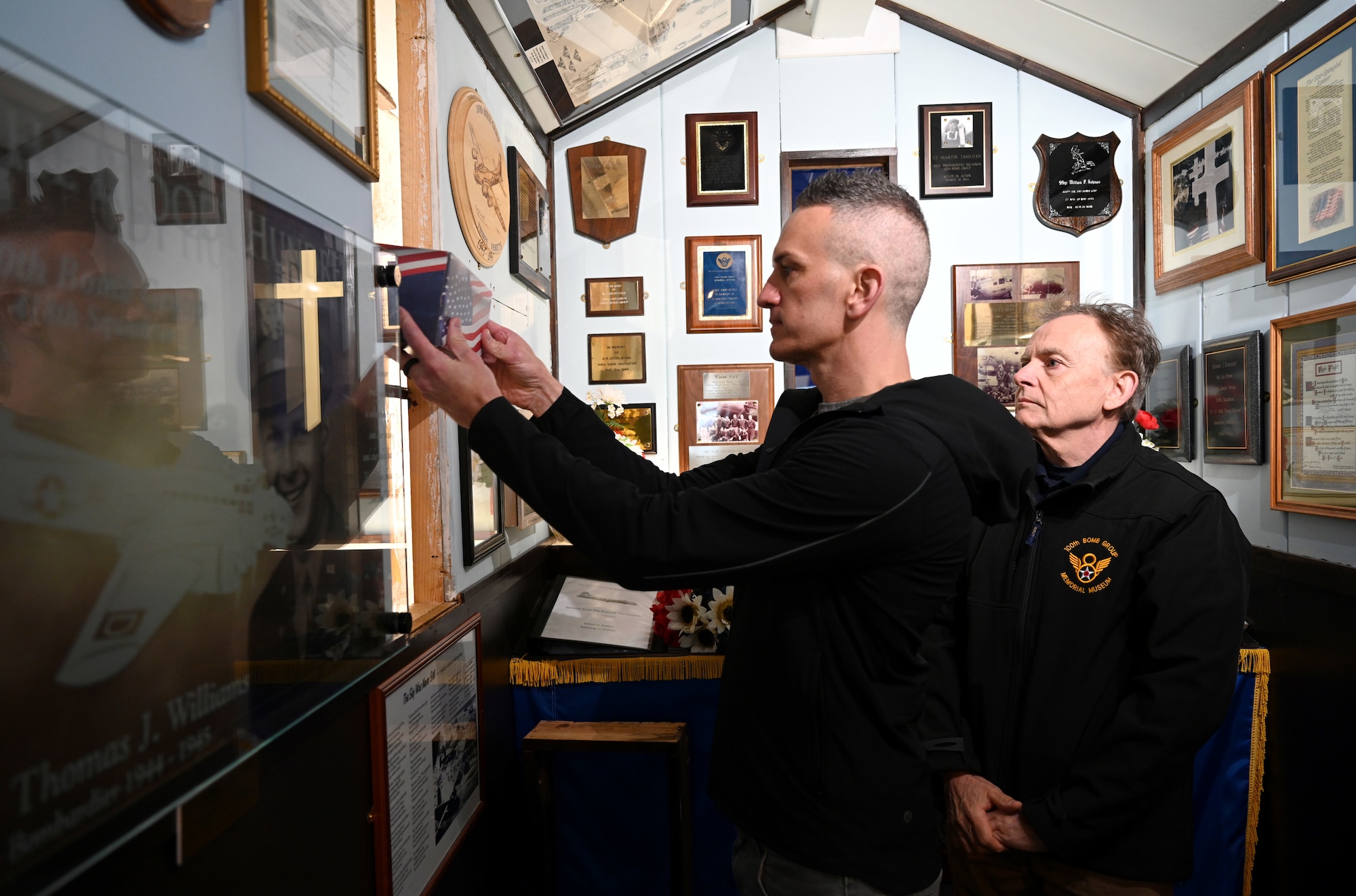 Jeffrey Paul Wolff, left, grandson of Capt. Robert “Bob” Wolff, World War II and 100th Bomb Group veteran, places some of his grandfather’s ashes inside the chapel at the 100th Bomb Group Memorial Museum with Dr. Reg Wilson, 100th BGMM chair of trustees, at Thorpe Abbotts, England, April 16, 2025. Capt. Wolff was a B-17 Flying Fortress pilot and passed away in October 2024 at age 103. (U.S. Air Force photo by Karen Abeyasekere)