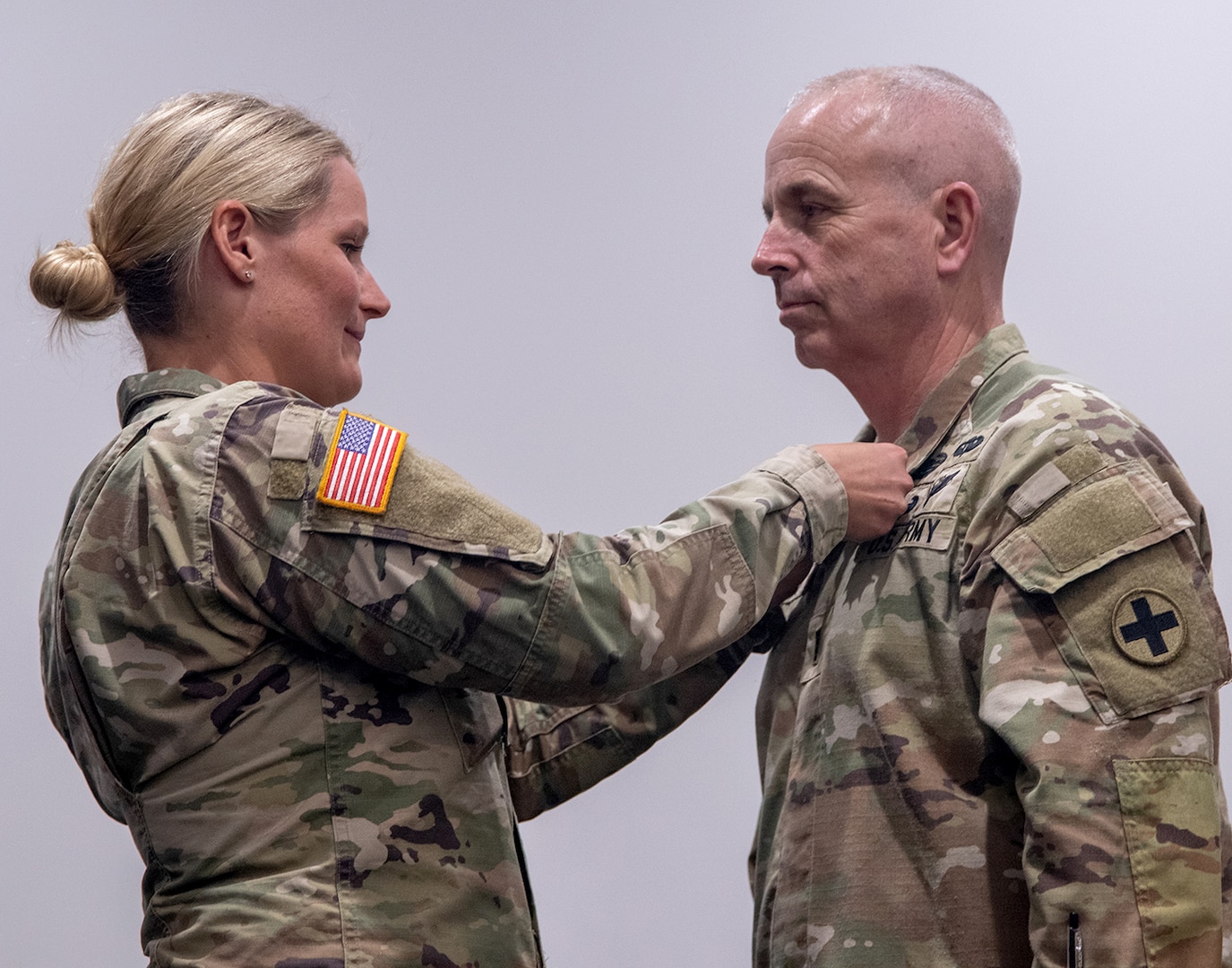 Capt. Allison Johnson, Commander, Company D, 766th Brigade Engineer Battalion, presents Chief Warrant Officer 4 Brian Berry with the Legion of Merit during a retirement ceremony May 2 at the Illinois Military Academy, Camp Lincoln, Springfield. Berry is retiring from the Illinois Army National Guard after 38 years of service.