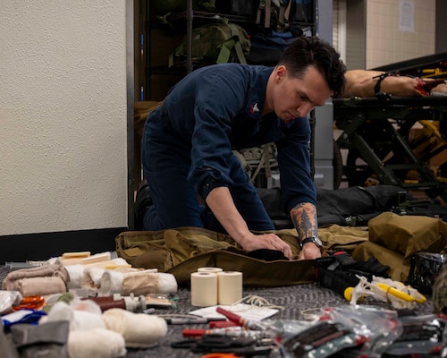 U.S. Navy Hospital Corpsman 2nd Class Raymond Eller, assigned to the Nimitz-class aircraft carrier USS George Washington (CVN 73), packs a medical equipment bag for a tactical combat casualty care training exercise at Yokota Air Base, Japan, April 3, 2025. The TCCC program trains all service members, including medical personnel, to perform medical care in austere conditions and out in the fleet or field. (U.S. Air Force photo by Senior Airman Samantha White)