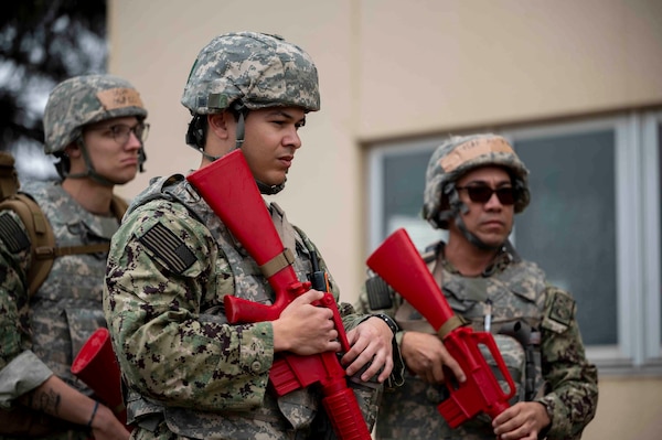U.S. Navy Hospital Corpsmen receive a brief before a tactical combat casualty care training exercise at Yokota Air Base, Japan, April 3, 2025. Yokota’s TCCC team ensures participants are well-prepared for any situation by integrating tactical principles and realistic scenarios that closely reflect challenges that may be faced in combat. (U.S. Air Force photo by Senior Airman Samantha White)