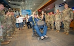A Vietnam veteran renders a salute from his wheelchair as he passes through the honor corridor at the Medford Airport, Medford, Ore., May 4, 2025. Oregon Army National Guard soldiers and Patriot Guard Riders formed the corridor to welcome veterans returning from an Honor Flight trip to Washington, D.C., where they visited military memorials honoring their service.