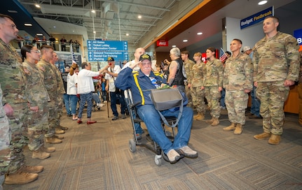 A Vietnam veteran renders a salute from his wheelchair as he passes through the honor corridor at the Medford Airport, Medford, Ore., May 4, 2025. Oregon Army National Guard soldiers and Patriot Guard Riders formed the corridor to welcome veterans returning from an Honor Flight trip to Washington, D.C., where they visited military memorials honoring their service.