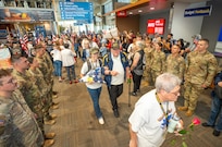Oregon Army National Guard soldiers from the 1st Battalion, 186th Infantry Regiment stand in formation alongside Patriot Guard Riders to create a welcome corridor for veterans returning from Honor Flight of Oregon at the Medford Airport, Medford, Ore., May 4, 2025. The four-day trip allowed veterans to visit war memorials in the nation's capital, showing them the nation's gratitude for their service.