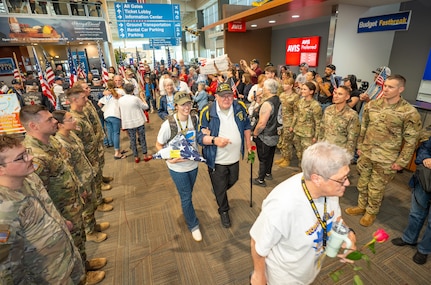 Oregon Army National Guard soldiers from the 1st Battalion, 186th Infantry Regiment stand in formation alongside Patriot Guard Riders to create a welcome corridor for veterans returning from Honor Flight of Oregon at the Medford Airport, Medford, Ore., May 4, 2025. The four-day trip allowed veterans to visit war memorials in the nation's capital, showing them the nation's gratitude for their service.