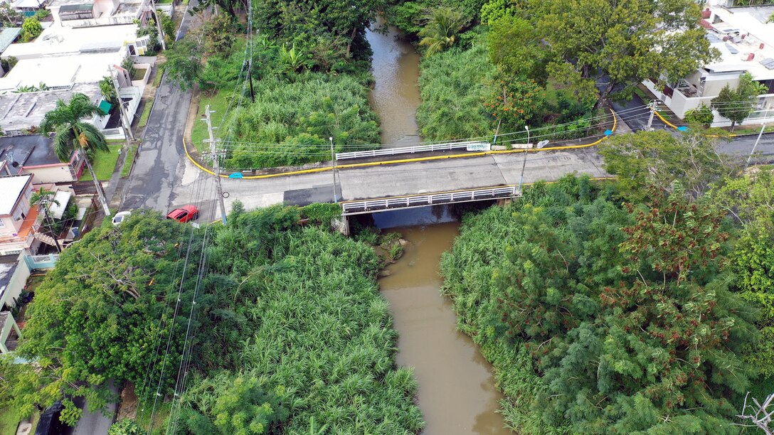 Aerial view of a river flowing through a neighborhood.