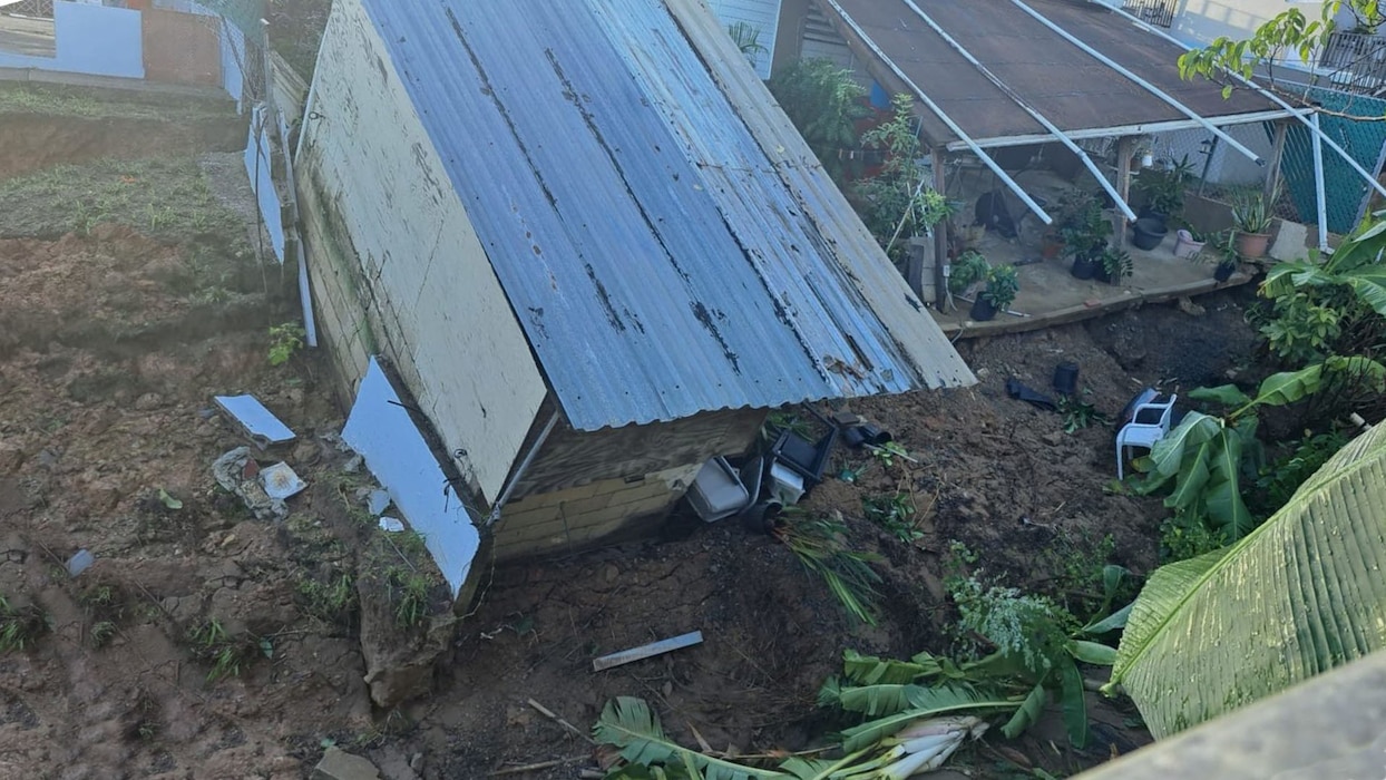 Erosion caused a shed and patio to fall into the river channel.