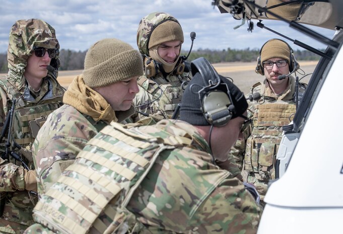 Servicemembers discuss during a training exercise.