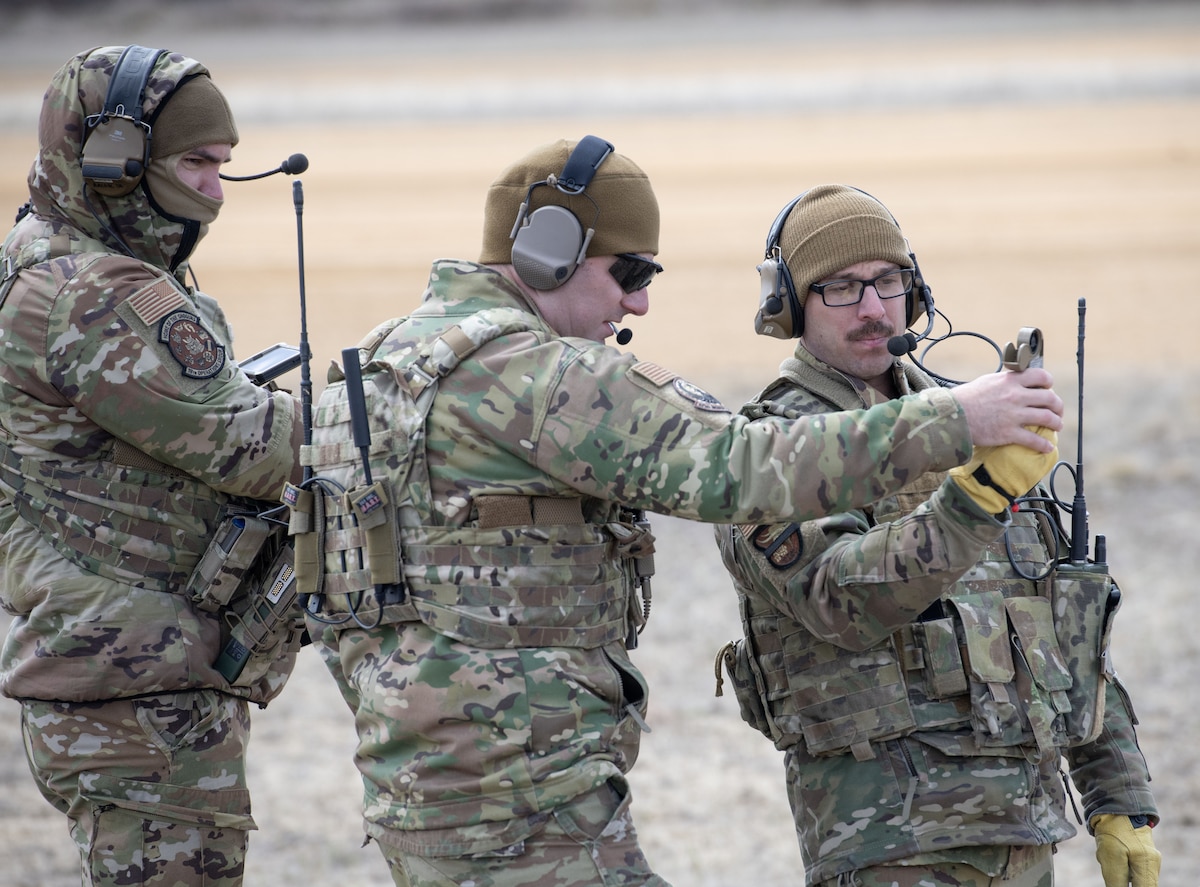 Military members discuss strategy during training.