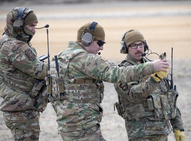 Military members discuss strategy during training.