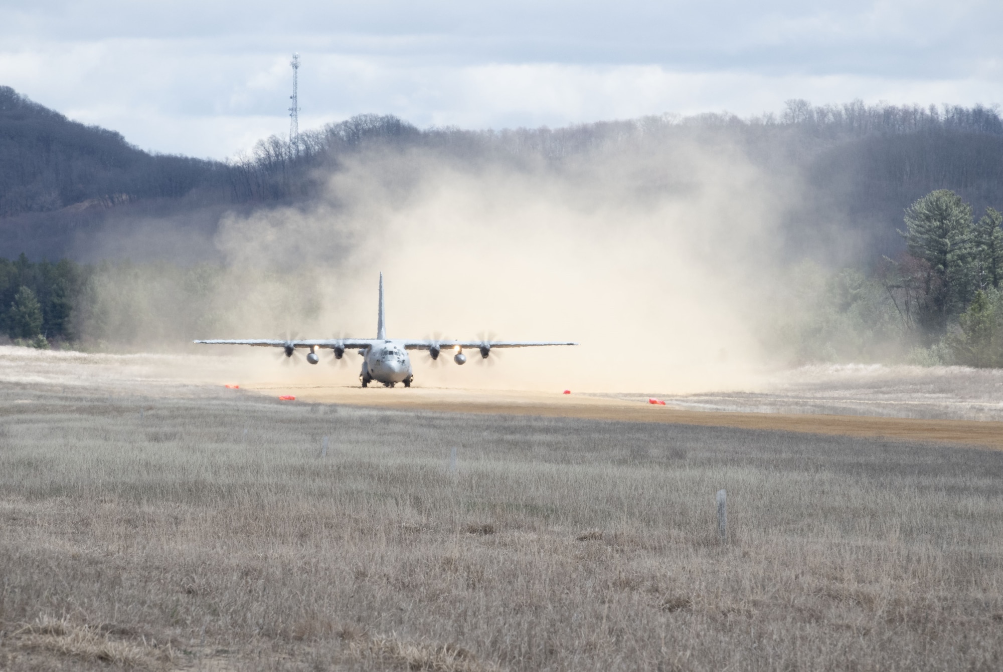C-130 Hercules lands onto an airstrip.