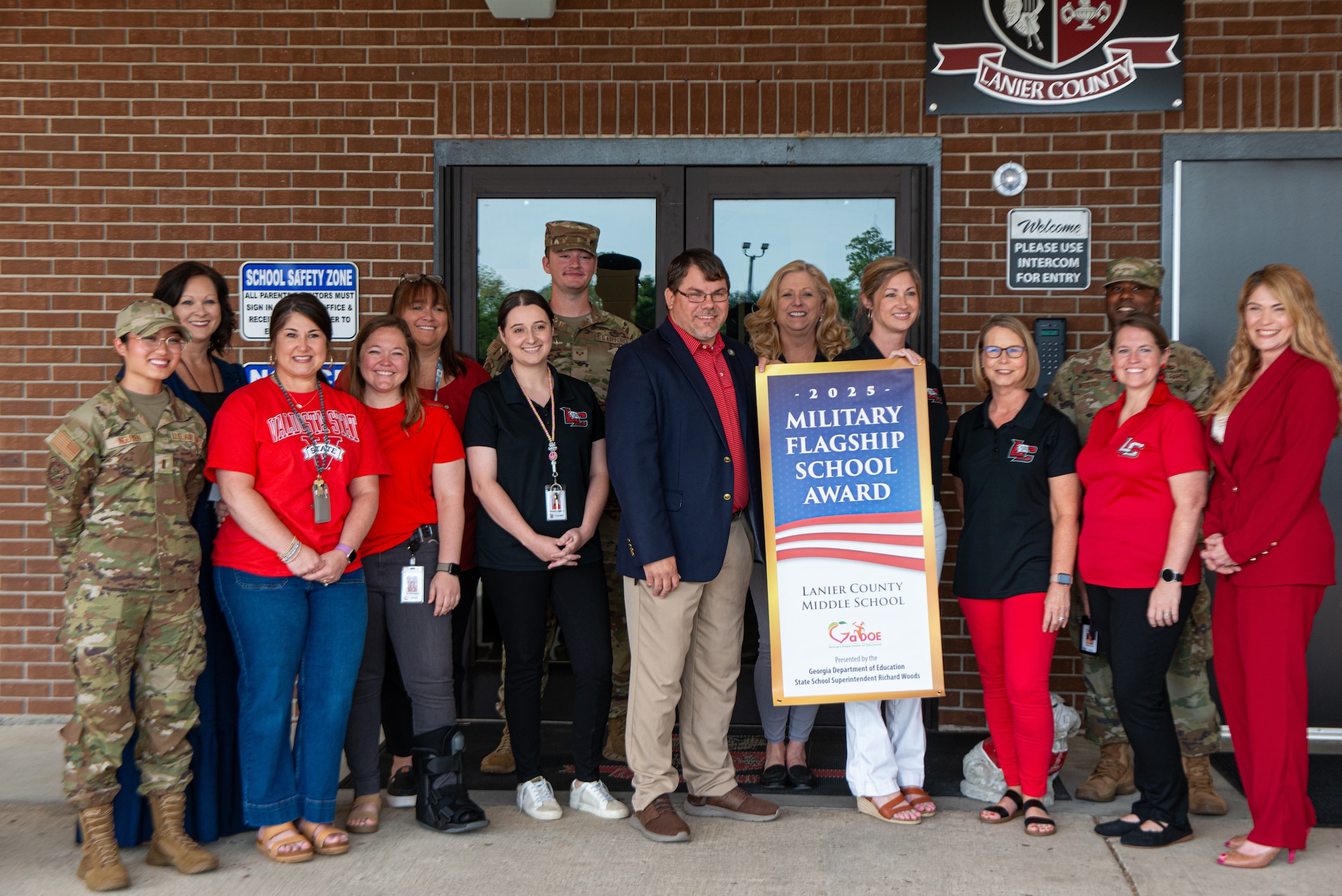 Group of teachers and military stand together.