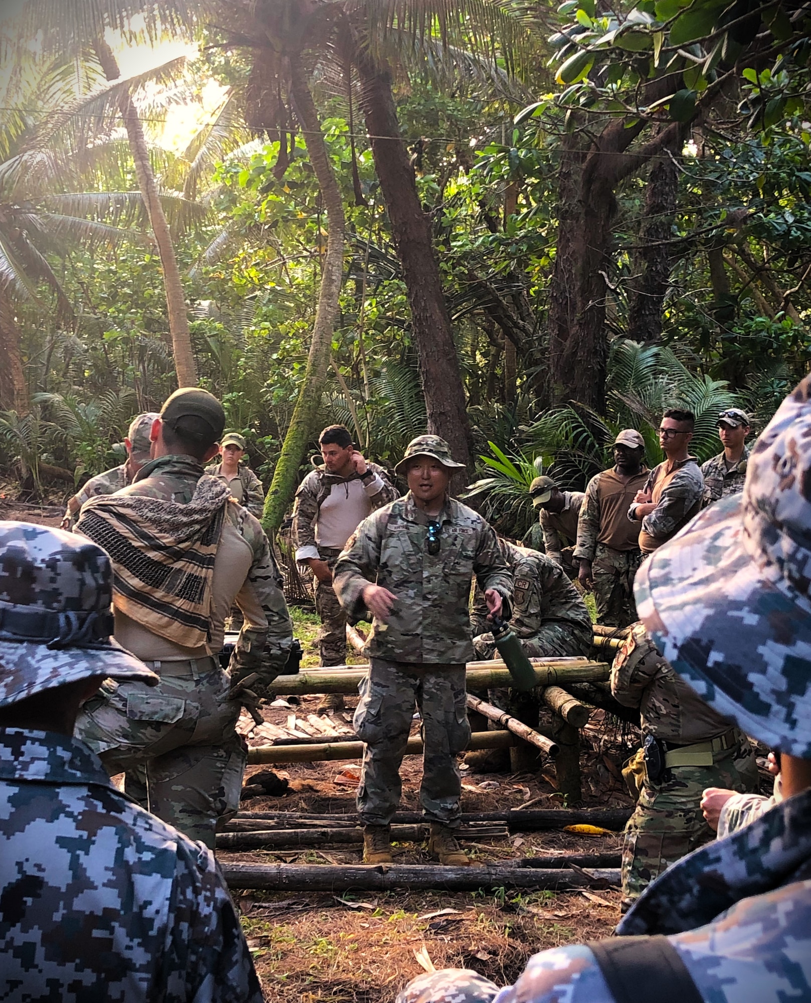 Senior Airman Tadayoshi Kiriyama, a Japanese LEAP Scholar, interprets a jungle survival briefing to members of the Japan Air Self-Defense Force Security Forces Team during the Pacific Defender 2023 exercise.
