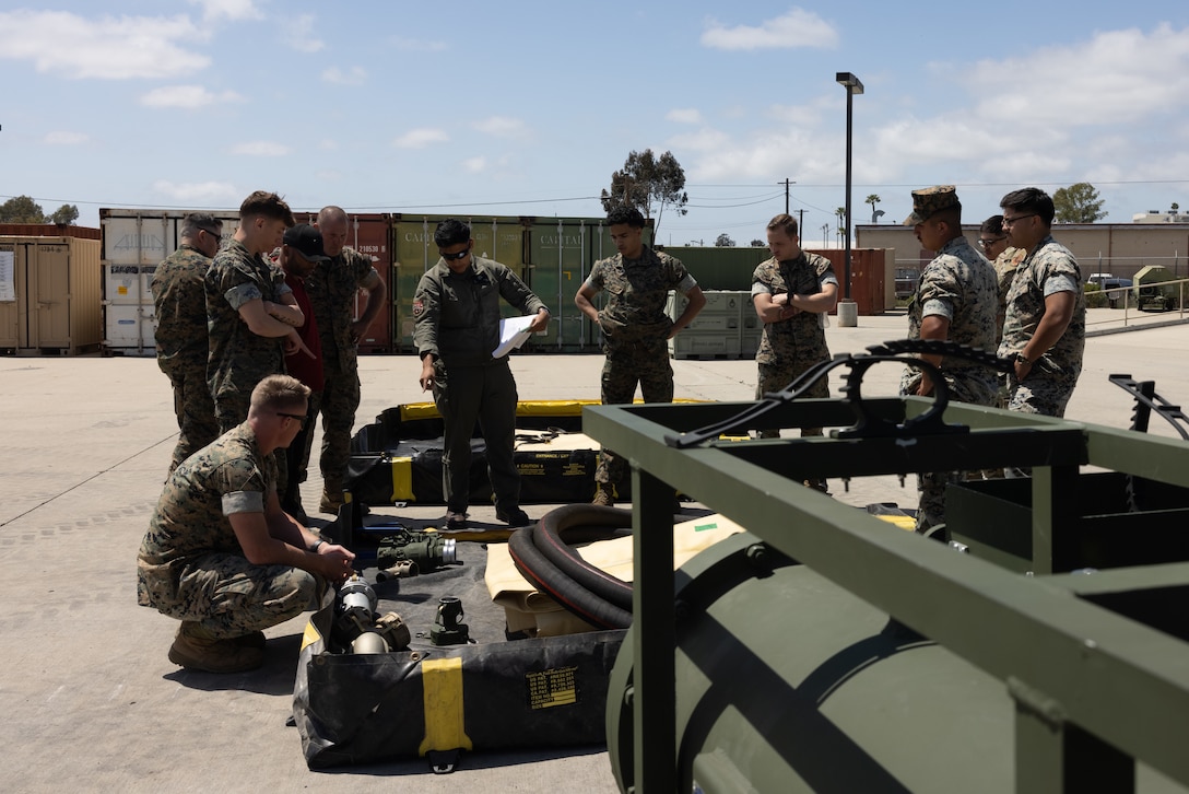 U.S. Marines and U.S. Airmen from the 27th Special Operations Mission Support Group, familiarize themselves with new equipment during Tactical Air-Ground Refueling System New Equipment Training at Marine Corps Air Station Miramar, California, April 23, 2025.   The TAGRS, an expeditionary Marine Corps-exclusive asset, is a compact mobile refueling system designed to expand the capabilities of Marine Corps’ Forward Arming and Refueling Points and Expeditionary Advanced Base Operations. TAGRS support refueling operations in forward areas and remote locations. (U.S. Marine Corps photo by Lance Cpl. Samantha Devine)