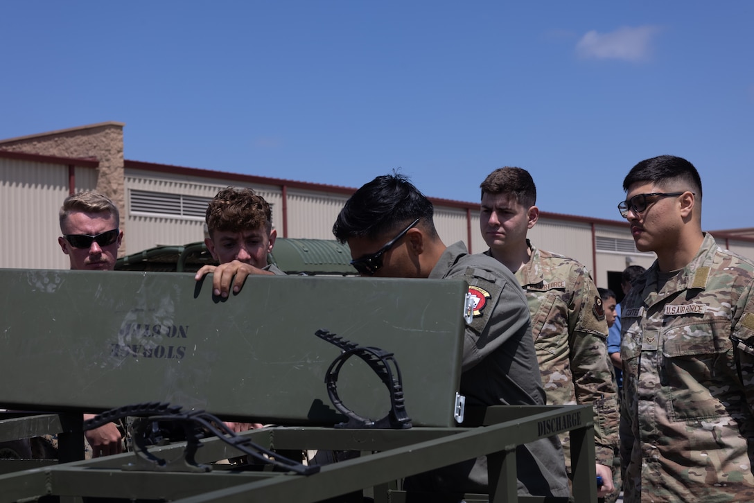 U.S. Marines and U.S. Airmen from the 27th Special Operations Mission Support Group, familiarize themselves with new equipment during Tactical Air-Ground Refueling System New Equipment Training at Marine Corps Air Station Miramar, California, April 23, 2025.  The TAGRS, an expeditionary Marine Corps-exclusive asset, is a compact mobile refueling system designed to expand the capabilities of Marine Corps’ Forward Arming and Refueling Points and Expeditionary Advanced Base Operations. TAGRS support refueling operations in forward areas and remote locations. (U.S. Marine Corps photo by Lance Cpl. Samantha Devine)