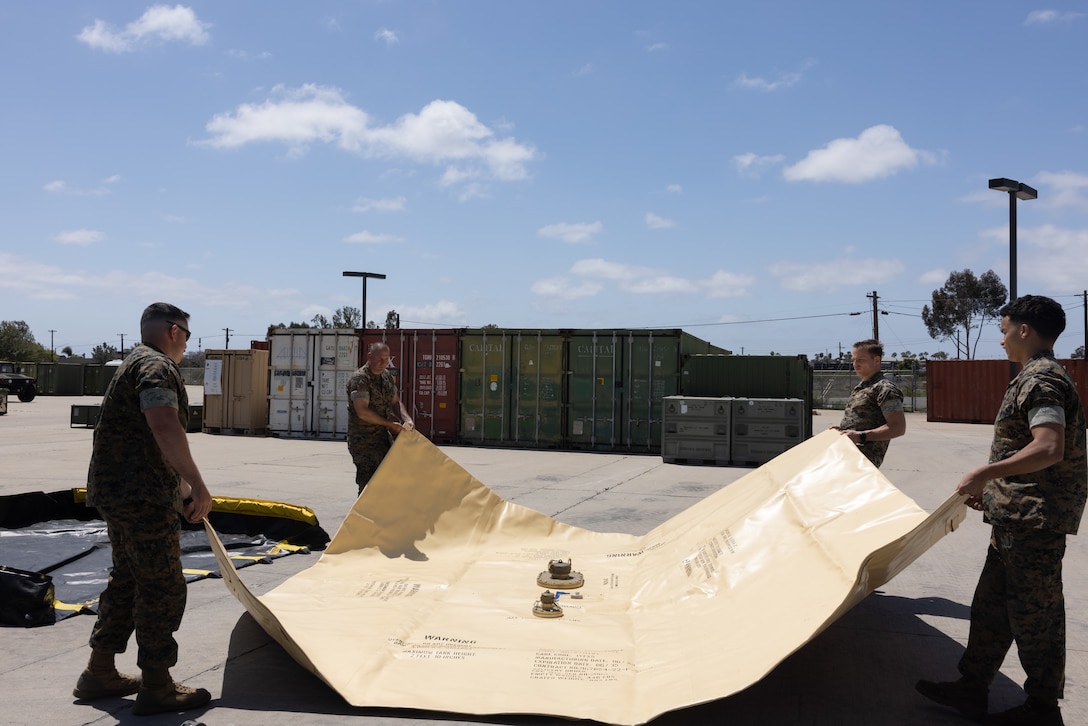 U.S. Marines from across the Marine Aircraft Wings lay out a collapsible fuel tank during Tactical Air-Ground Refueling System New Equipment Training at Marine Corps Air Station Miramar, California, April 23, 2025. The TAGRS, an expeditionary Marine Corps-exclusive asset, is a compact mobile refueling system designed to expand the capabilities of Marine Corps’ Forward Arming and Refueling Points and Expeditionary Advanced Base Operations. TAGRS support refueling operations in forward areas and remote locations. (U.S. Marine Corps photo by Lance Cpl. Samantha Devine)