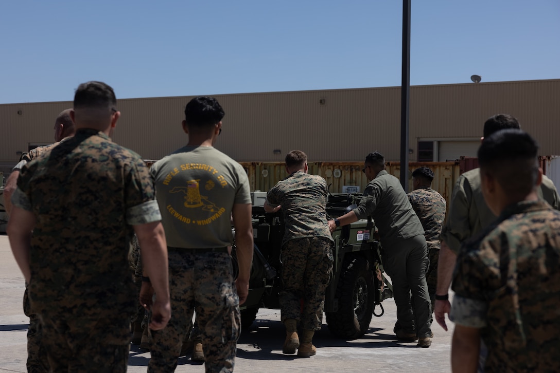 U.S. Marines from across the Marine Aircraft Wings move a Tactical Air-Ground Refueling System during a New Equipment Training at Marine Corps Air Station Miramar, California, April 24, 2025.  The TAGRS, an expeditionary Marine Corps-exclusive asset, is a compact mobile refueling system designed to expand the capabilities of Marine Corps’ Forward Arming and Refueling Points and Expeditionary Advanced Base Operations. TAGRS support refueling operations in forward areas and remote locations. (U.S. Marine Corps photo by Lance Cpl. Samantha Devine)