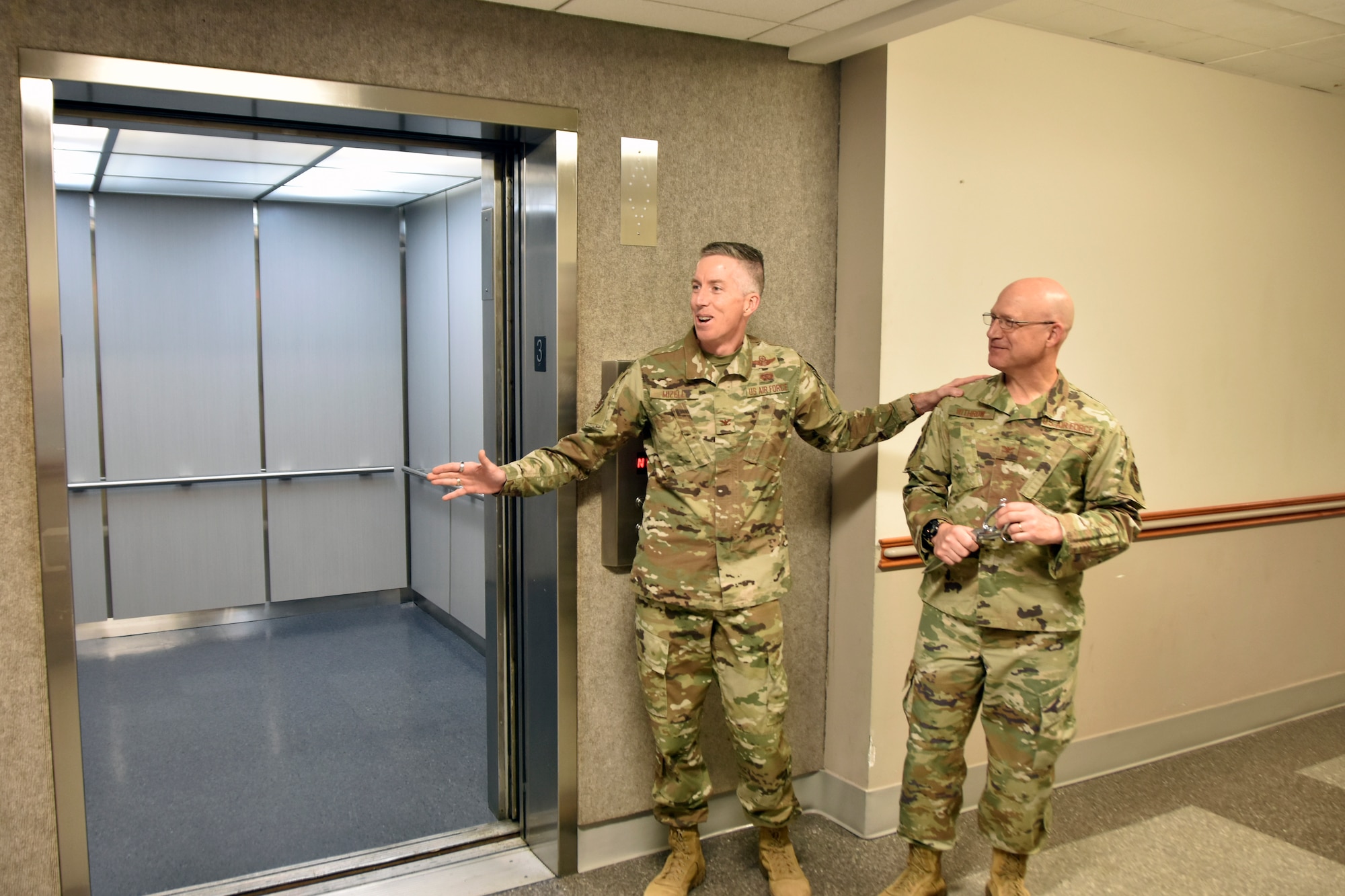 Col. Grant Mizell, Arnold Engineering Development Complex commander, left, speaks following a ribbon cutting for the new elevator in the Administration and Engineering Building at Arnold Air Force Base, Tenn., May 5, 2025. Arnold AFB is the headquarters of AEDC. Also pictured is Col. Eric Withrow, AEDC Test Support Division chief. The process of replacing the elevator was a two-year effort overseen by the AEDC Civil Engineering Branch. The previous elevator had been in place since construction of the building and was originally intended to serve as a cargo elevator. (U.S. Air Force photo by Bradley Hicks)