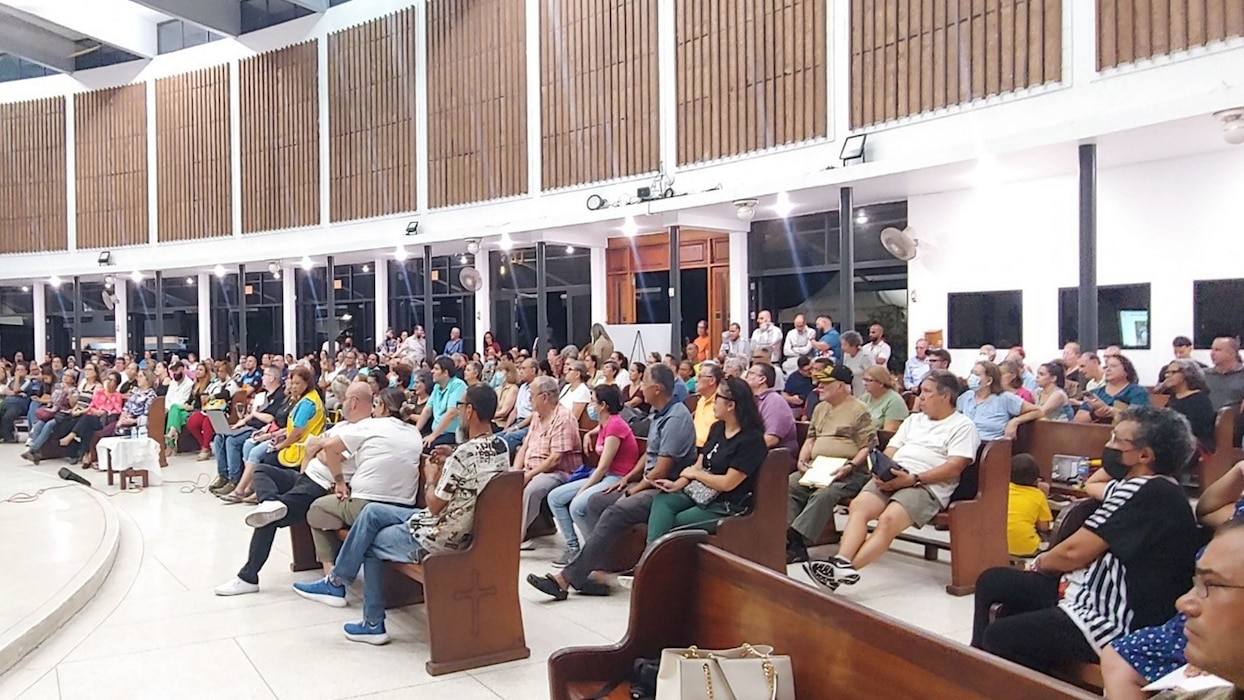 People in a room watching a presentation.