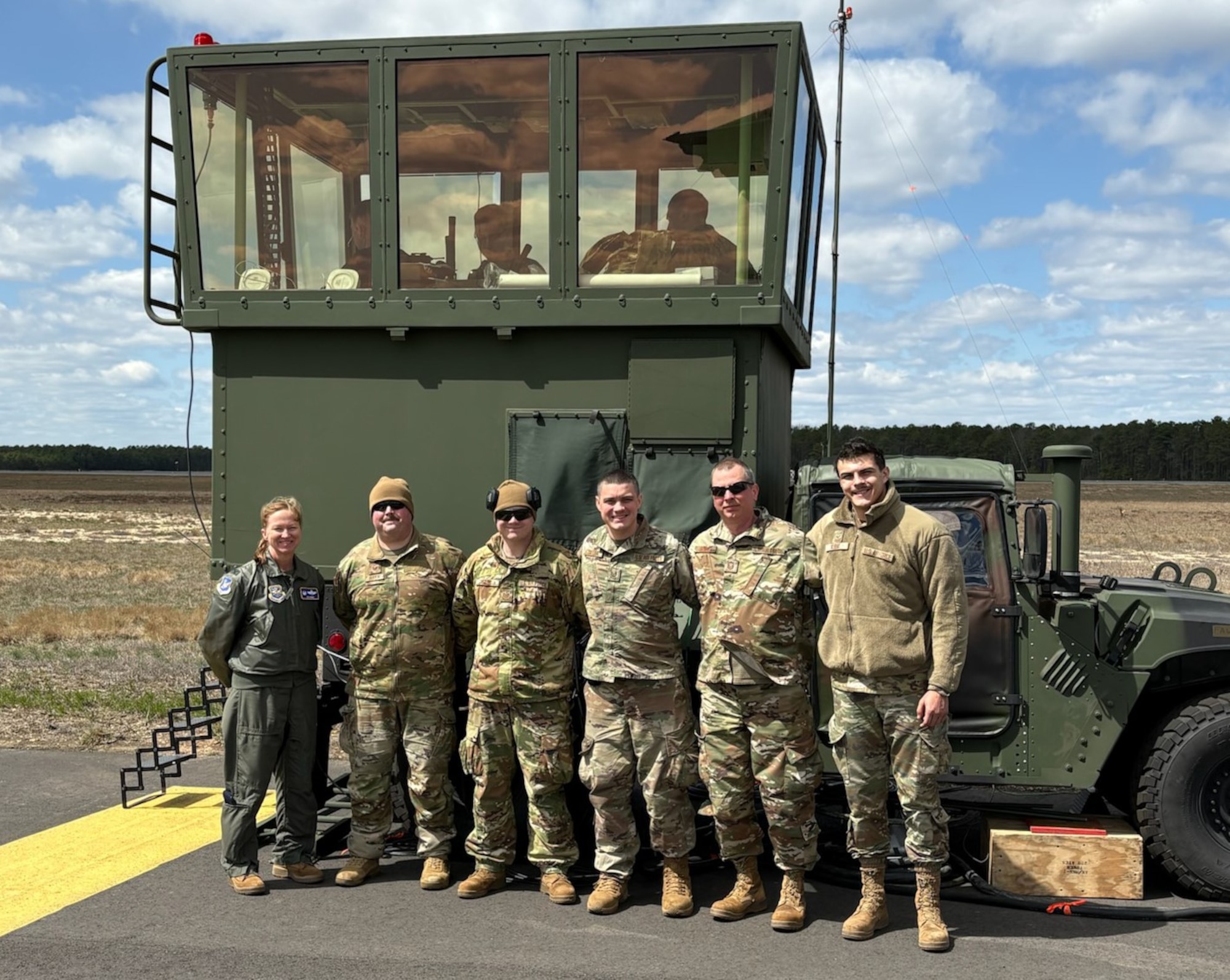 From left, U.S. Air Force Col. Kathleen Hasson, 305th Air Mobility Wing commander, Tech. Sgts. Christopher Roth, Michael Sabo, and Stephen Snyder, Master Sgt. John Babl and Senior Airman Ethan Kubat, 258th Combat Airfield Operations Squadron Mobile Special Navigational Aid-7 personnel, pose for a photo in front of the MSN-7 tower at Joint Base McGuire-Dix-Lakehurst, N.J., April 8, 2025. In a display of Total Force Integration, active-duty Airmen, Sailors and Air National Guard teams successfully deployed and activated the MSN-7 tower at Lakehurst’s Maxwell Field while the main tower underwent refurbishment allowing for uninterrupted support to mission readiness and operational capability. (U.S. Air Force photo by Staff Sgt. Nicholas Nalback)