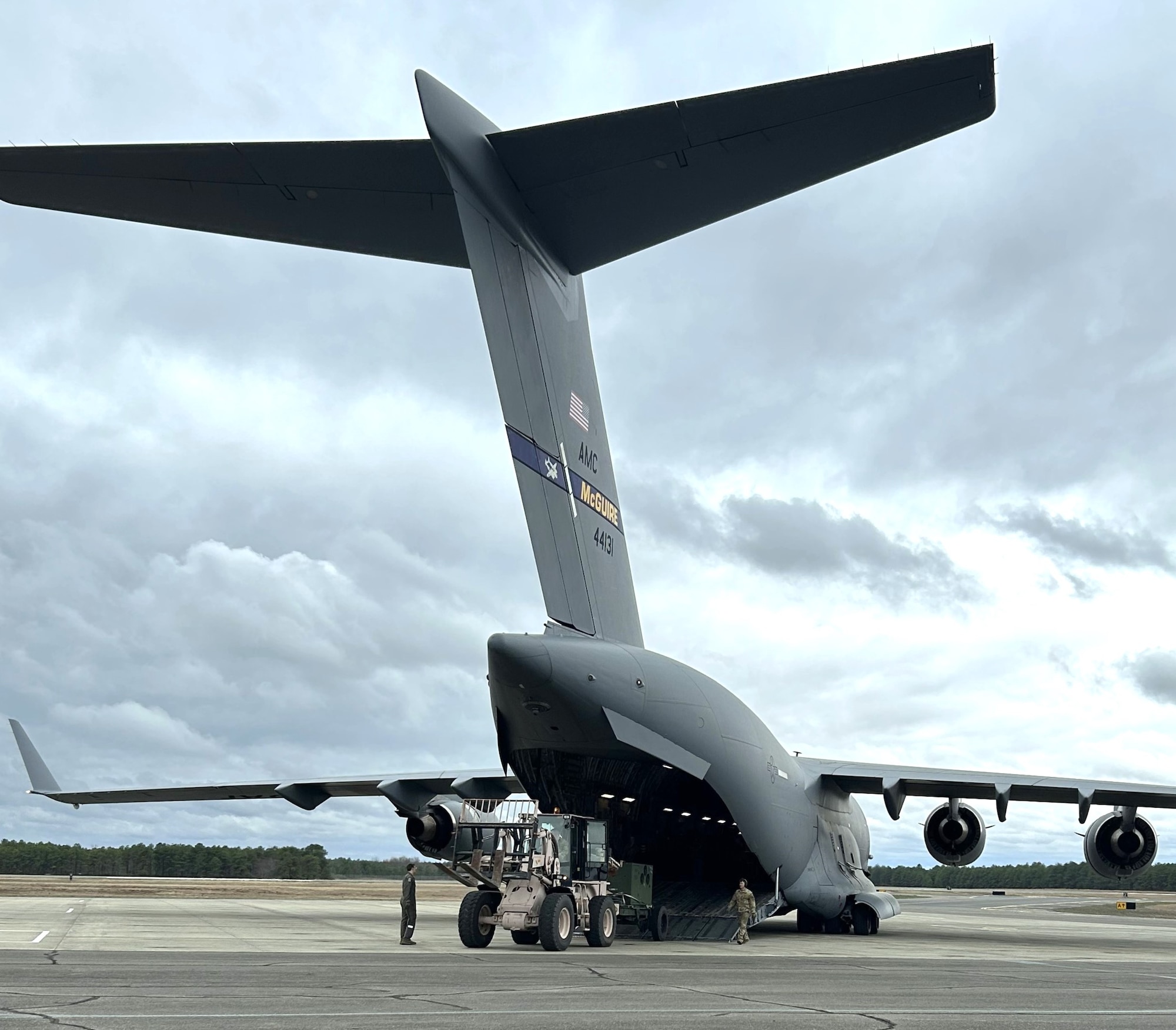 A C-17A Globemaster III crew, led by Lt. Col. Justin Paulson, 732nd Airlift Squadron acting director of operations, performs an engine-running offload of the Mobile Special Navigational Aid-7 tower at Joint Base McGuire-Dix-Lakehurst, N.J. April 6, 2025. In a display of Total Force Integration, active-duty Airmen, Sailors and Air National Guard teams successfully deployed and activated the MSN-7 tower at Lakehurst’s Maxwell Field while the main tower underwent refurbishment allowing for uninterrupted support to mission readiness and operational capability. (U.S. Air Force photo by Lt. Col. David Bishop)