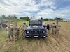 U.S. Army soldiers with 1st Multi-Effects Battalion, 1st Multi-Domain Task Force and a service member from the Philippine Air Force pose for a group photo after mounting an Unmanned Aerial System to the roof of a Philippine Air Force vehicle in preparation to use as a launch vehicle for future flights during Exercise Balikatan 25 in Palawan, Philippines, May 1, 2025.