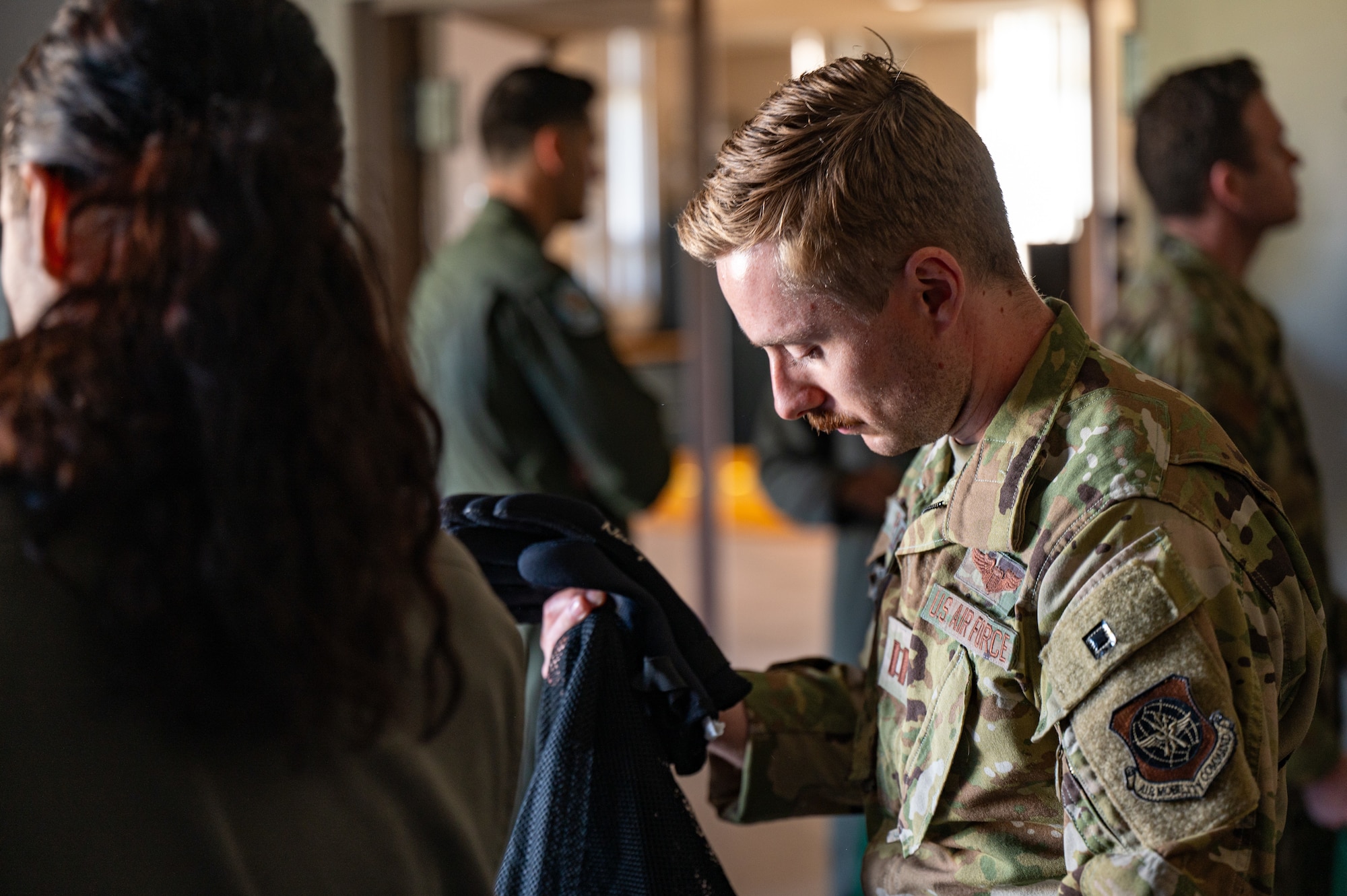 U.S. Air Force Capt. Cody Pelletier, 3rd Airlift Squadron pilot, loads his gear into a mesh bag during the Water Survival Preparation course at Dover Air Force Base, Delaware, April 29, 2025. During the classroom portion of the WSP course Airmen learned about the different emergency devices typically aboard an aircraft and ways to mitigate sun exposure and dehydration.