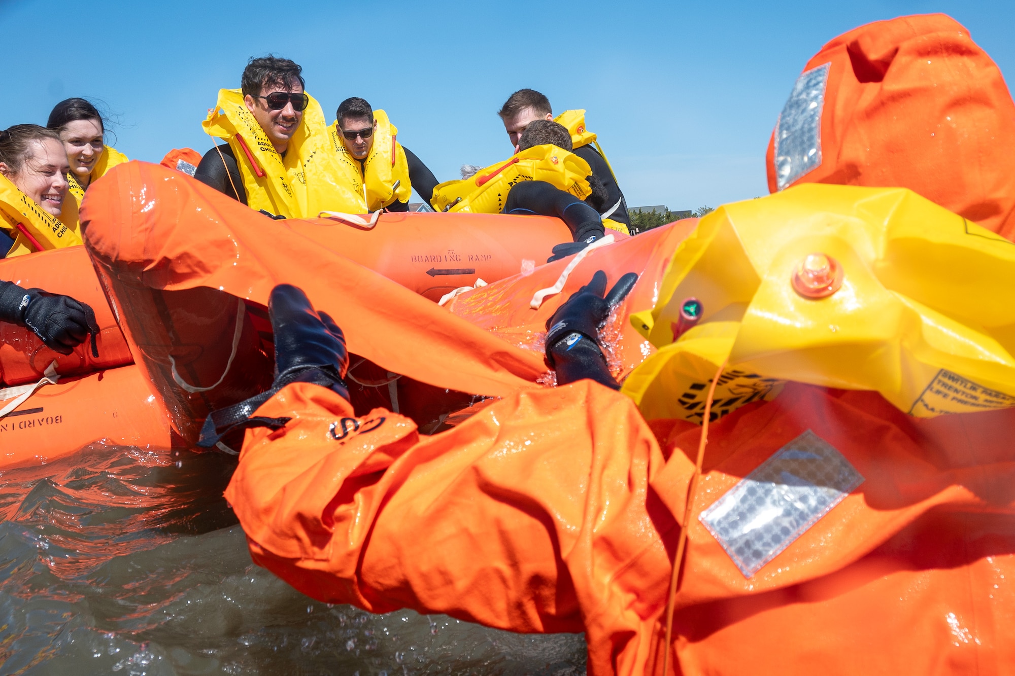 Team Dover Airmen climb onto a 20-person life raft during their Water Survival Preparation course at Bowers Beach, Delaware, April 29, 2025. The Water Survival Preparation course reinforces Airmen’s knowledge and best practices for survival in the event of a downed aircraft over open water.