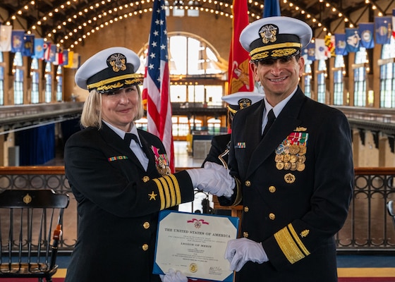 (250411-N-IX644-1003) ANNAPOLIS, Md. Capt. Lydia Doye is presented with the Legion of Merit from Rear Adm. Rick Freedman, Navy Deputy Surgeon General and Deputy Chief, Bureau of Medicine and Surgery, during her retirement ceremony in Dahlgren Hall at the United States Naval Academy, April 11, 2025. Doye served in the Navy for 27 years and was recognized for her exceptionally meritorious conduct in the performance of outstanding services. (U.S. Navy photo by Mass Communication Specialist 2nd Class Sasha Ambrose)