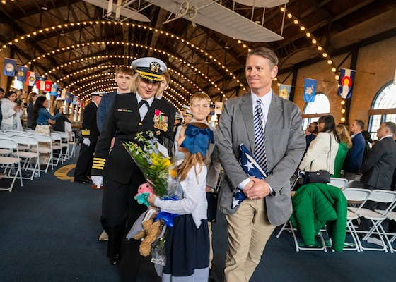 (250411-N-IX644-1045) ANNAPOLIS, Md. Capt. Lydia Doye and her family are piped ashore during her retirement ceremony in Dahlgren Hall at the United States Naval Academy, April 11, 2025. Doye served in the Navy for 27 years, building, training, and developing Sailors as a pilot and later as a human resources officer. (U.S. Navy photo by Mass Communication Specialist 2nd Class Sasha Ambrose)