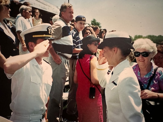 (250411-N-N1526-2001) ANNAPOLIS, Md. Ens. Lydia Doye, right, receives her first salute from Ens. Matt Smith during graduation at the United States Naval Academy, Annapolis, Maryland in 1998. (Courtesy photo provided by Capt. Lydia Doye)
