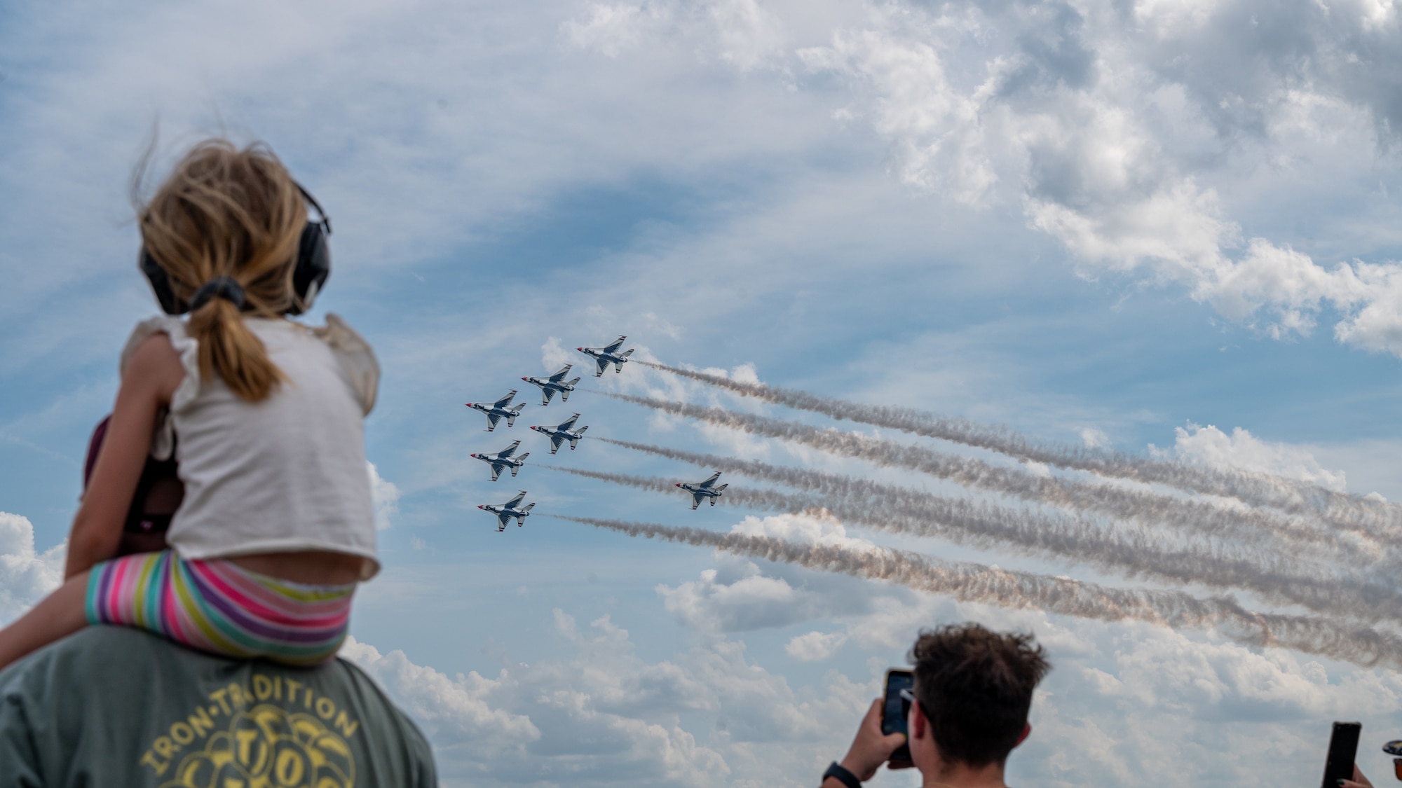 Members of the local populace watch the U.S. Air Force Thunderbirds during the Wings Over Wayne Open House 2025 at Seymour Johnson Air Force Base, North Carolina, May 2, 2025. The event provided an opportunity for the public to connect with the Airmen and experience the capability of the Air Force firsthand. (U.S. Air Force photo by Senior Airman Leighton Lucero)