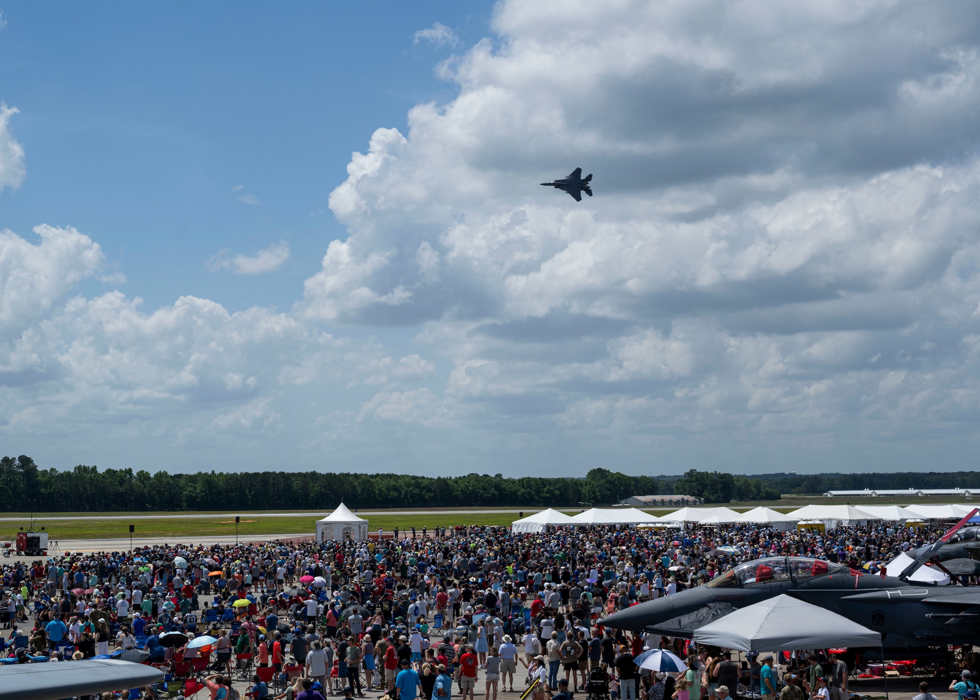 Members of the Wayne County community watch as a U.S. Air Force F-15E Strike Eagle completes a live fire demo during the Wings Over Wayne Open House 2025, at Seymour Johnson Air Force Base, North Carolina, May 3, 2025. The event provided an opportunity for the public to connect with the Airmen and experience the capability of the Air Force firsthand. (U.S. Air Force photo by Staff Sgt. David Lynn)