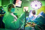 Army Col. (Dr.) Caela Miller, Department of OB/GYN deputy chief, performs a robotic hysterectomy for cervical dysplasia at Brooke Army Medical Center, Fort Sam Houston, Texas, Feb. 2, 2022. A robotic hysterectomy uses surgeon-controlled robotic equipment to remove the uterus. Cervical dysplasia is the abnormal growth of cells on the surface of the cervix and could lead to cancer if left untreated. (U.S. Army photo by Jason W. Edwards) (Jason W. Edwards)