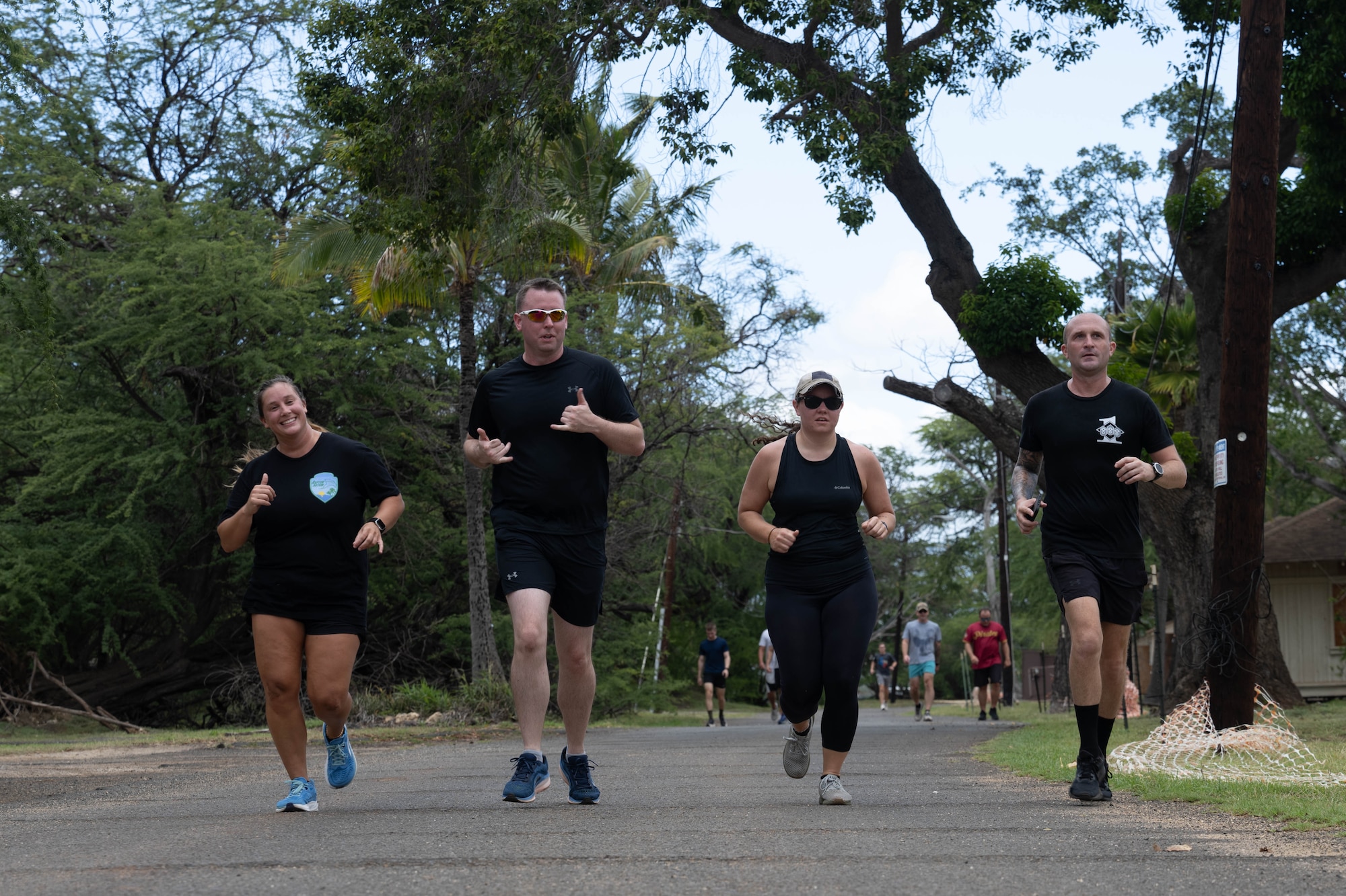 U.S. Air Force Airmen run down a road as part of a physical training challenge on Joint Base Pearl Harbor-Hickam, Hawaii.