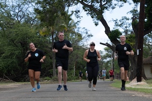 U.S. Air Force Airmen run down a road as part of a physical training challenge on Joint Base Pearl Harbor-Hickam, Hawaii.
