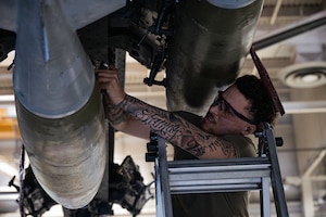 Senior Airman Nicholas Bowden, 69th Bomber Generation Squadron load crew member, secures an inert GBU-31 Joint Direct Attack Munition to a B-52H Stratofortress during the 1st Quarter Weapons Load Competition at Minot Air Force Base, May 2, 2025. Weapons load competitions play a significant role in enhancing mission readiness and strengthening global strike capabilities. (U.S. Air Force photo by Senior Airman Alyssa Bankston)